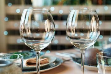 Beautiful elegant table setting with green stylish dishware and silver cutlery