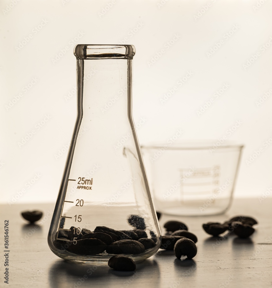 Sticker Close up shot of coffee beans in laboratory glassware being tested