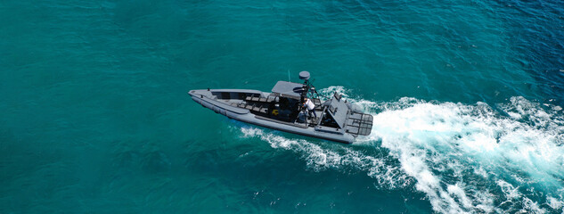 Aerial drone ultra wide photo of rigid inflatable speed boat cruising in deep blue Aegean sea,...