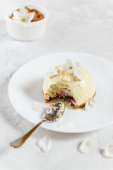 Almond cake with cherry on a white plate. Raw food dessert, vegetarian, vegan.