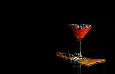 Raspberrie smoothie in glass on black background