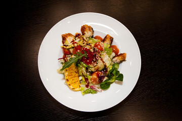 tasty food on a white plate on a black background