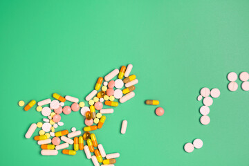 Close up of many different pills on blue background.