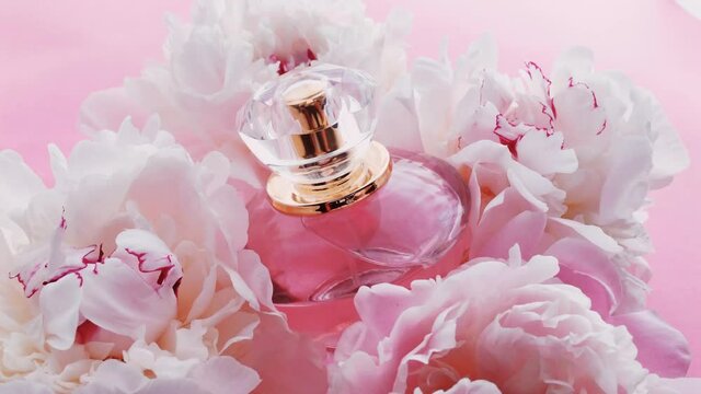 Pink perfume bottle with peony flowers, chic fragrance scent as luxury cosmetic, fashion and beauty product backgrounds