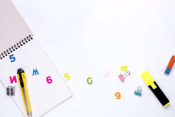 Many different school supplies on white copy space background. Back to school concept.