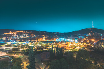 Tbilisi, Georgia. Modern Urban Night Cityscape. Evening Night Scenic View Of City Center