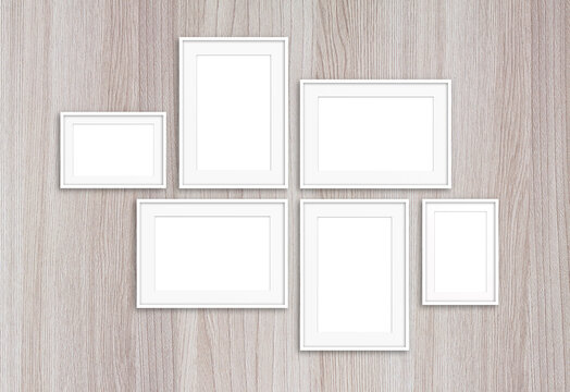 Six white photo frames on textured wall, interior decoration mock up