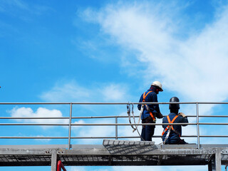 Man Working on the Working at height on construction site with blue sky