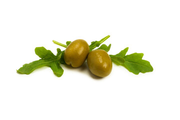 Two olives and leaves of arugula  isolated on white