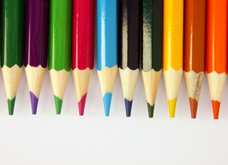 Colored pencils on a white background. Lots of different colored pencils. Colored pencil. Pencils are sharp. Pencils lie on the above. Beautiful background. Close-up. Copy space. Background. Flat lay