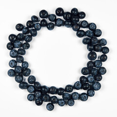 nature and healthy food concept - Top view of fresh blueberries isolated on white background. Copy space. Round frame.