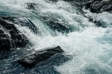 Deurstickers Big rapids of powerful mountain river. Beautiful background with azure water in fast river. Frozen motion of tall mountain river rapids. Power majestic nature of highlands. Backdrop of aqua turbulence © Daniil