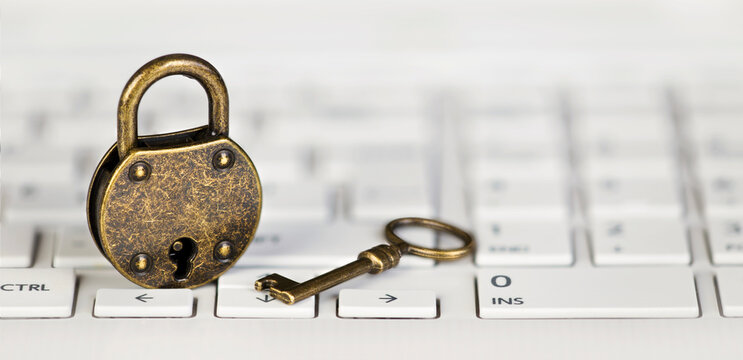 Internet Online Privacy, Web Security Concept, Padlock And Gold Key On A White Computer Laptop Keyboard. Web Banner.