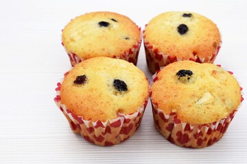 Delicious homemade vanilla muffins with raisins and pieces of white chocolate