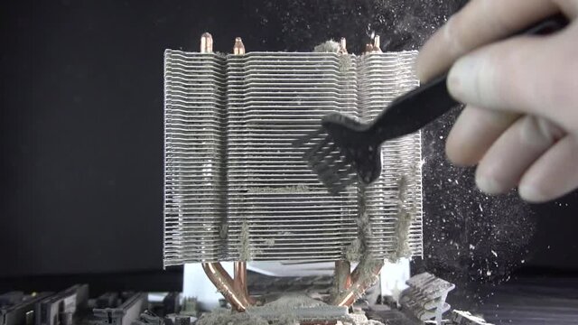 Dust pollution. Cleaning the processor radiator sink from dust. Antistatic brush. Slow motion.