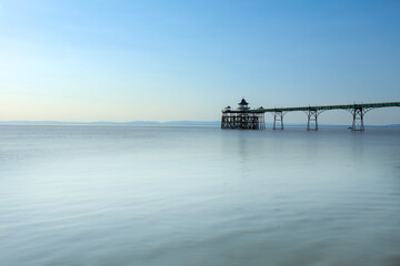 The Clevedon pier in a noon time with calm clear sky and water
