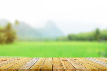 Shelf of Brown wood plank board with blurred green rice field farm with mountain and hut nature...