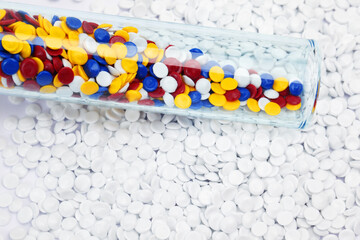 abstract of multicolored industrial plastic pellet on white background