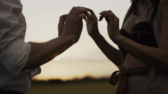 Slow motion shot of couple dancing outdoors and holding hands
