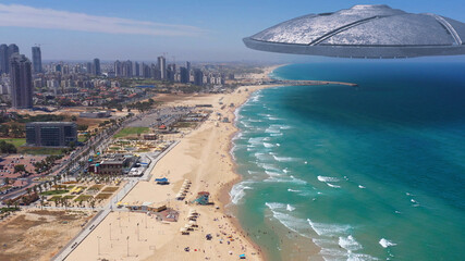 Alien ufo Saucers spacecraft flying over sea and coastline of large city.
Drone view with visual...