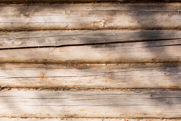 wooden logs in the sun with shadows