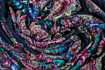 top view closeup folded dark soft cotton scarf with bright floral print