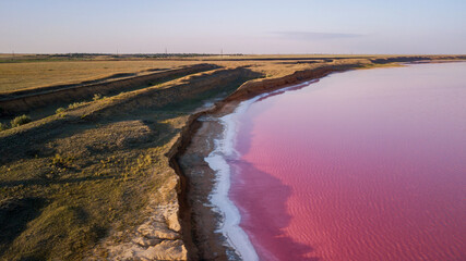 Scenic colorful Pink Salt Lake in Ukraine. unusual color cause of an algae with red pigments.  Amazing seascape.
