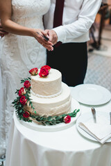 wedding ceremony. the bride and groom make their first case together, cut the white wedding cake