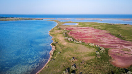 amazing aerial view of blue and pink lakes, sea on horizon. Beautiful natural landscape. Drone shot, bird's eye.