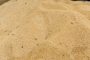 Fototapeta na wymiar Close up sand background. Sunny sand texture