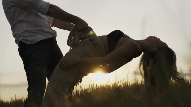 Slow motion shot of couple dancing outdoors in the evening