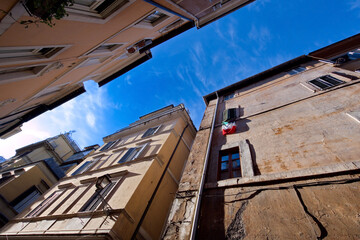 Fototapeta na wymiar Bottom to top, clear sky view in a tipical lane in Rome