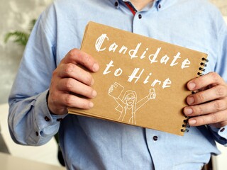 Business concept about Candidate to Hire with sign on the piece of paper.