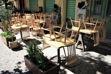 Greece, Athens, June 17 2020 - Chairs stacked outside of a traditional restaurant in the touristic district of Monastiraki.