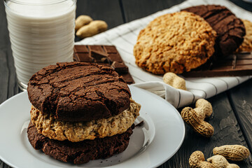 Chocolate and oat cookies on dark wooden table