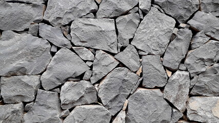 grey stone background close-up. dark stone wall texture
