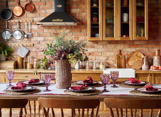 Serving for dinner on kitchen table. Warm kitchen background interior.