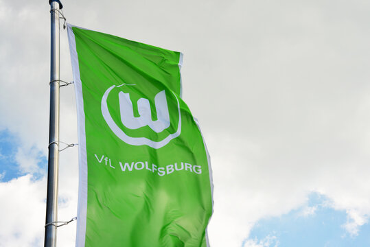 Wolfsburg, Lower Saxony / Germany - May 21, 2017: Flag of German football club VfL Wolfsburg against blue sky in Wolfsburg, Germany