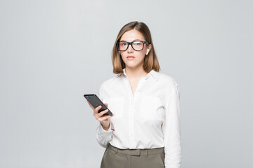 Naklejka premium Young beautiful business woman talking via airpods wirrless headset holding phone isolated on white background