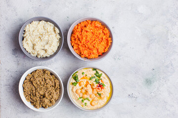 Bowls of various dip sauces on white background