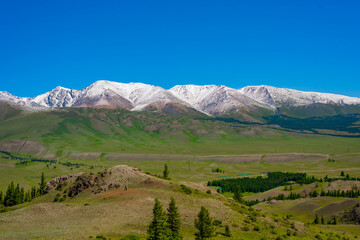Fototapeta na wymiar Mountain range with melting snow. View from the valley