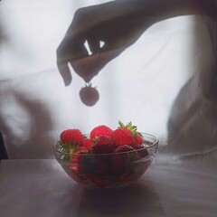 strawberry in a hand