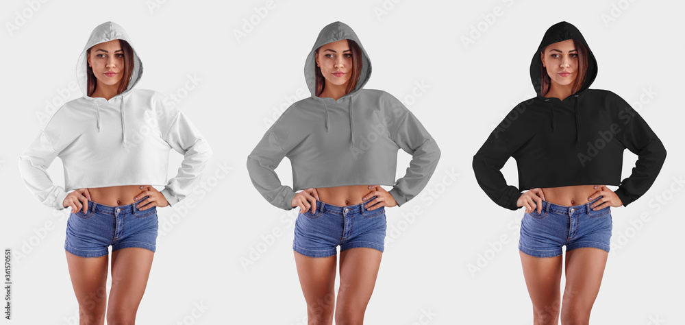 Wall mural Template white, gray, black hoodie on a sports girl in blue shorts, with hands on the waist, a set of empty clothes on a background in the studio. - Wall murals