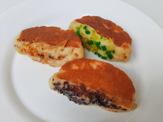 Pukis, is an Indonesian traditional pancake, with various toppings. On white plate. Isolated in white background.