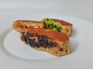Pukis, is an Indonesian traditional pancake, with various toppings. On white plate. Isolated in white background.