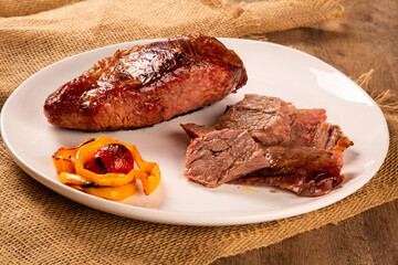 Hot Grilled Whole Tri-tip Steak or rump skirt on a plate