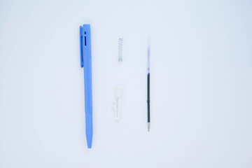 Blue ballpoint pen isolated on white background. Pivot of the ball pen. Ballpoint parts.