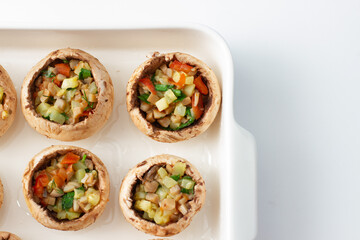 Cooking stuffed champignons in a baking dish. Close-up. Top view