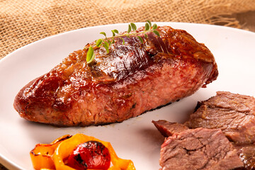 Hot Grilled Whole Tri-tip Steak or rump skirt on a plate