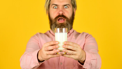 Milk Pasteurization in Dairy Processing Plant. selective focus. surprised man hold glass of milk. pasteurized milk. Man offer tasty vegan glass. buy milk in supermarket